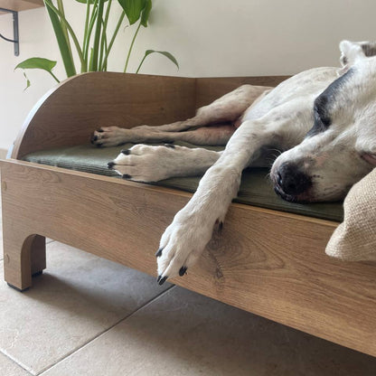 Close-up of orthopedic mattress insert for wooden dog bed showing supportive foam